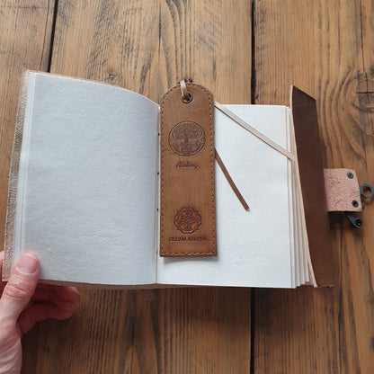 Open journal with white recycled cotton pages and leather tree of life embossed bookmark