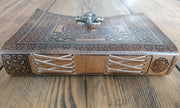 Side and top view of leather hand bound journal resting on wooden table