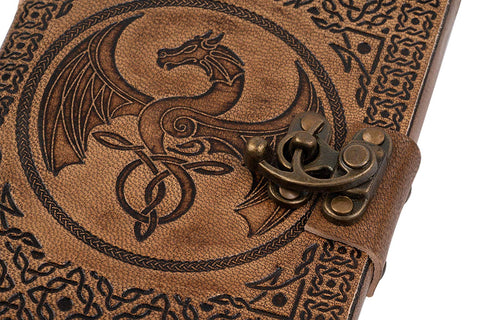 Close up of Celtic dragon embossing on leather journal with brass metal clasp