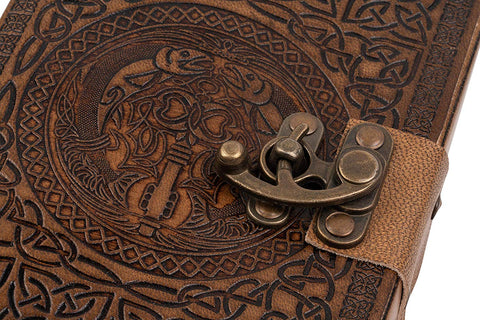 Close up of Celtic design embossing and brass metal clasp secured journal